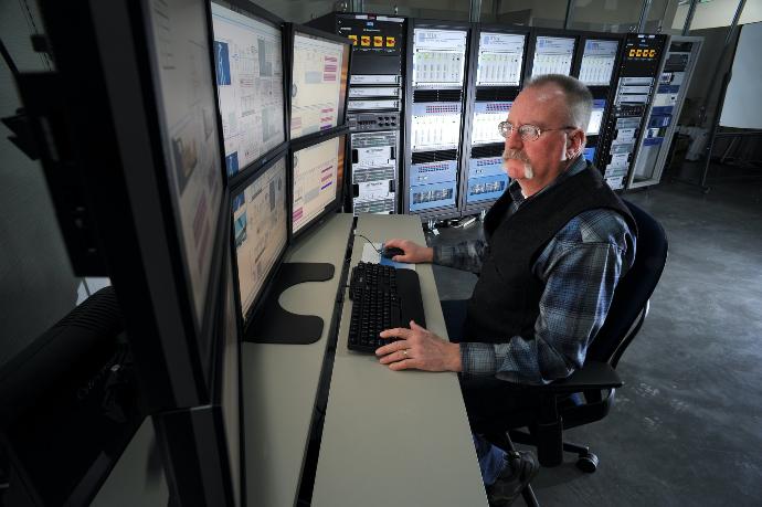 man sitting on rolling chair in front of computer